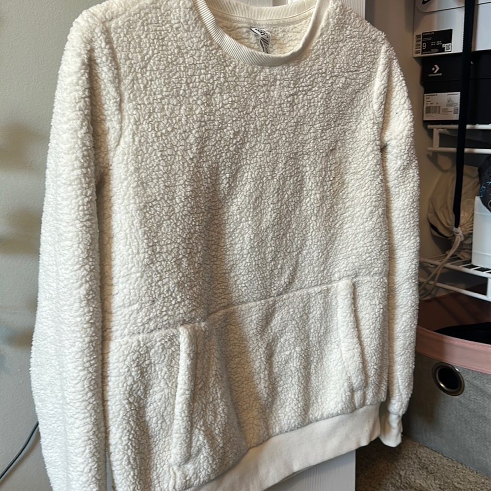 I am selling a white fuzzy sweater from athletic girls, a size extra large 14